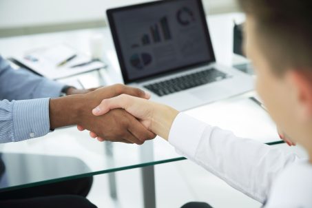closeup.strong financial partners shaking hands over a Desk.the concept of partnership